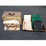 A 20th century Singer electric sewing machine together with a box containing Pilgrims progress