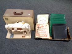 A 20th century Singer electric sewing machine together with a box containing Pilgrims progress