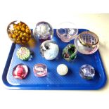 A tray of nine glass paperweights including Caithness,