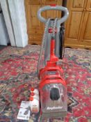 A Rug Doctor carpet cleaner with instructions together with three bottles of rug doctor fabric and