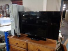 A Warmlite oil filled radiator together with a Bush 32 inch LCD TV with remote