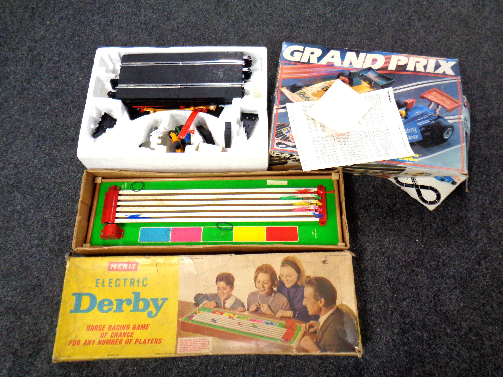 A Scalextric Grand prix racing set together with a Merit Derby horse racing game