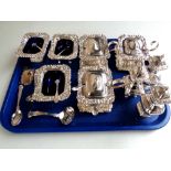 A tray of silver plated wares, castors, straining spoon, mustard pots,