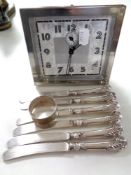 A twentieth century Scottish LSM chrome plated alarm clock together with a set of six handled