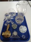 A tray of glass paperweights, mantel clock, brass gavel,