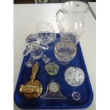 A tray of glass paperweights, mantel clock, brass gavel,