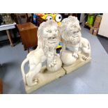 A pair of plastic lion garden figures,