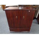 A double door television cabinet in mahogany finish