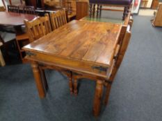 A rectangular Sheesham wood dining table and four chairs