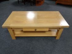 A contemporary oak two-tier coffee table fitted drawer.
