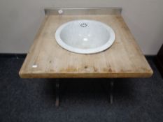 A reclaimed pine sink unit with antique ceramic sink on a cast iron base