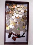 A tray of pre decimal and European coins together with two miniature pipes