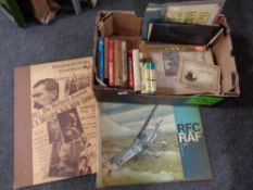 A box containing paper ephemera, reproduction newspapers,