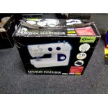 A boxed Delta Essentials 24 programme sewing machine