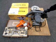 A diamond wheel tile cutter boxed together with a Black and Decker two-speed drill,