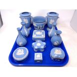 A tray of Wedgwood blue and white Jasperware including lidded trinket pots,