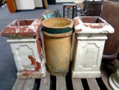A pair of antique painted chimney pots together with a further chimney pot