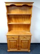A pine double door Welsh dresser fitted with two drawers