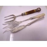 A silver fish knife together with two carving forks with silver mounts