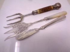 A silver fish knife together with two carving forks with silver mounts