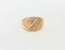 A 9ct gold signet ring set with a small diamond, size R. CONDITION REPORT: 2.