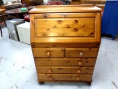 A Ducal pine fall fronted bureau fitted with five drawers