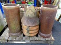 A pair of antique chimney pots together with a further chimney pot cap