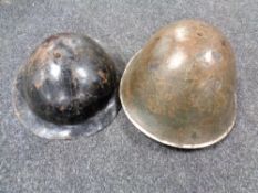 Two World War II tin helmets
