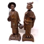 A pair of Japanese cast metal figures of a lady and gentleman