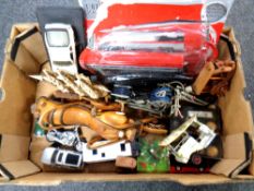 A box of plastic and die cast vehicles,