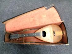An antique mandolin in case (Af)