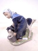 A Royal Copenhagen figure of a milkmaid with calf