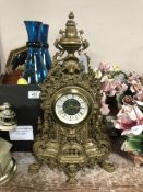 An antique style brass mantel clock,
