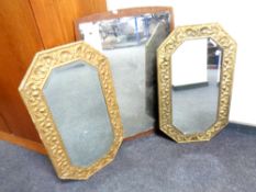 Two octagonal brass framed bevelled mirrors together with a further frameless mirror mounted on