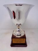 A silver plated trophy cup on stand