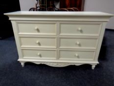 A contemporary six drawer chest together with matching pair of bedside stands (cream)