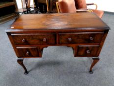 A 20th century stained walnut four drawer dressing table,