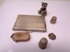 A silver card case, two silver thimbles,