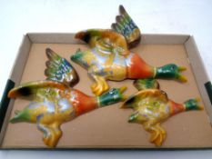 A graduated set of three pottery flying duck ornaments (af)