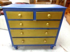 An antique painted pine five drawer chest