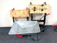 A metal wheel barrow together with two Workmates