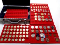 An aluminium coin collector's case containing four lift out trays containing commemorative coins,