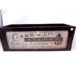 A wooden box bearing Clark & Co sewing cotton advertising