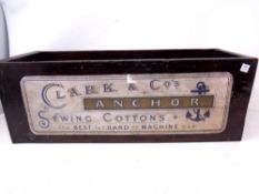 A wooden box bearing Clark & Co sewing cotton advertising