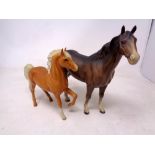 A Beswick figure of a horse together with a further foal figure