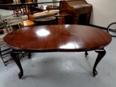 A 19th century mahogany wind-out table fitted with two leaves