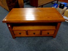A Morris Furniture oak coffee table fitted with undershelf and three drawers