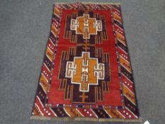 A Baluchi rug 136cm by 89cm