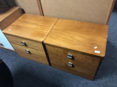A pair of 20th century teak two drawer bedside chests