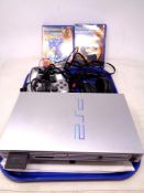 A Sony PS2 (silver), with two controllers,